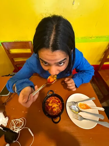 Hreem enjoying a meal at a restaurant.