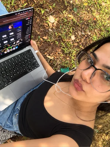 Hreem outdoors with her laptop.