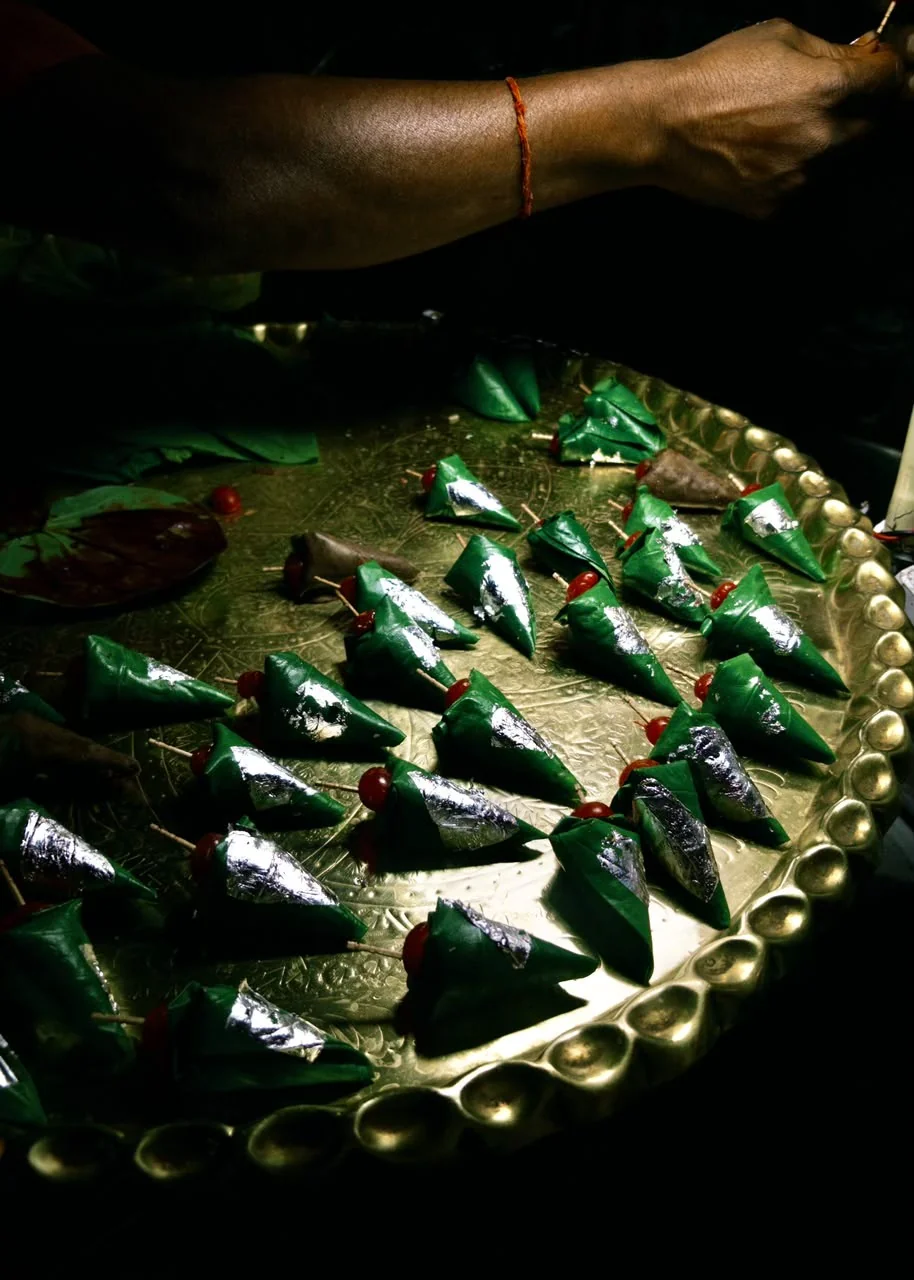 Silver-topped paan arranged on a brass tray.