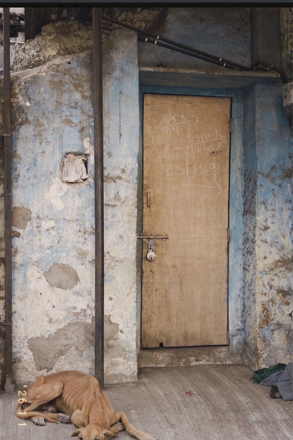 A doorway with worn blue paint.